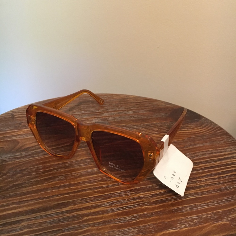 Women’s Shiny Plastic Unique Shape Sunglasses - a new day light orange